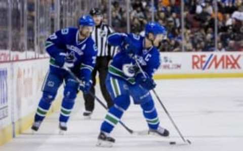 Nov 22, 2015; Vancouver, British Columbia, CAN; Vancouver Canucks center Henrik Sedin (33) drops a pass to forward Daniel Sedin (22) against the New Jersey Devils at Rogers Arena. Mandatory Credit: Bob Frid-USA TODAY Sports