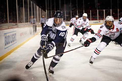 BOSTON, MA – JANUARY 14: Northeastern Huskies forward Zach Aston-Reese (12) attempts poke checks University of New Hampshire Wildcats forward Jason Salvaggio (10) during the first period of the game between the University of New Hampshire Wildcats and the Northeastern Huskies on January 14, 2017 at Fenway Park in Boston, MA. (Photo by John Kavouris/Icon Sportswire via Getty Images)