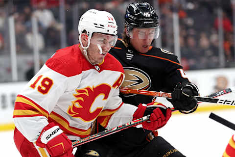 ANAHEIM, CALIFORNIA – APRIL 06: Matthew Tkachuk #19 of the Calgary Flames checks Trevor Zegras #46 of the Anaheim Ducks at the faceoff circle during the third period of a game at Honda Center on April 06, 2022 in Anaheim, California. (Photo by Sean M. Haffey/Getty Images)