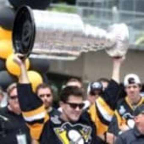 Jun 15, 2016; Pittsburgh, PA, USA; Pittsburgh Penguins defenseman Ben Lovejoy (12) holds the cup on stage during the Stanley Cup championship parade and celebration in downtown Pittsburgh. Mandatory Credit: Charles LeClaire-USA TODAY Sports