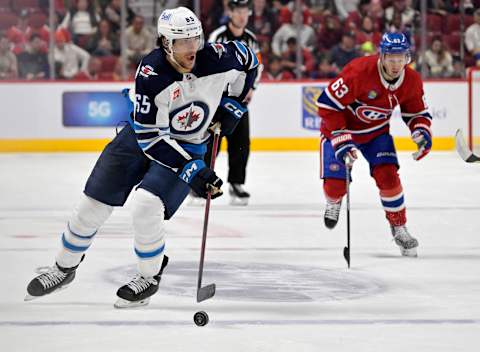 Winnipeg Jets, Johnathan Kovacevic (65), Montreal Canadiens, Evgenii Dadonov (63). Mandatory Credit: Eric Bolte-USA TODAY Sports