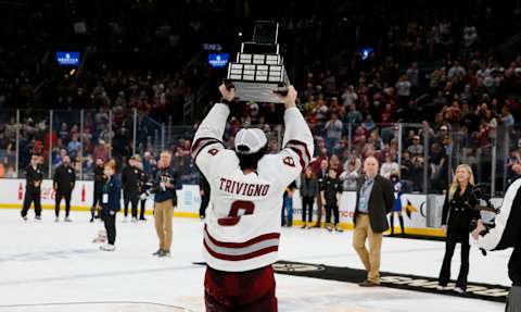 Bobby Trivigno #8 of the Massachusetts Minutemen raises the Lou Lamoriello Trophy after a 2-1 overtime victory against the Connecticut Huskies during NCAA men’s hockey in the Hockey East Championship Final at TD Garden on March 19, 2022 in Boston, Massachusetts. This is the second consecutive Hockey East Championship for the Minutemen. (Photo by Richard T Gagnon/Getty Images)