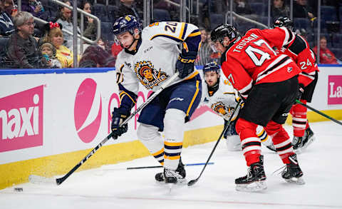 QUEBEC CITY, QC – OCTOBER 26: Olivier Nadeau #20 of the Shawinigan Cataractes and Charle Truchon #47 of the Quebec Remparts battle for the puck during their QMJHL hockey game at the Videotron Center on October 26, 2019 in Quebec City, Quebec, Canada. (Photo by Mathieu Belanger/Getty Images)