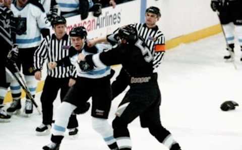 Nashville Knights’ Gary Lebsack, center left, and Columbus Chill’s Craig Binns (5) battle it out near the end of the first period as officials wait for a moment to break it up. The Knights went on to a 6-4 victory before 3,130 fans at Municipal Auditorium Jan. 6, 1995.95then01 021