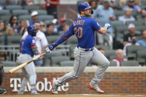 May 17, 2021; Atlanta, Georgia, USA; New York Mets first baseman Pete Alonso (20) hits a single against the Atlanta Braves in the first inning at Truist Park. Mandatory Credit: Brett Davis-USA TODAY Sports