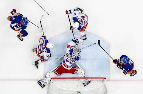 UNIONDALE, NEW YORK – APRIL 11: Igor Shesterkin #31 of the New York Rangers covers the puck against the New York Islanders. (Photo by Bruce Bennett/Getty Images)