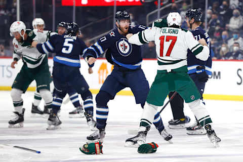 Winnipeg Jets, Adam Lowry (17), Brenden Dillon (5); Minnesota Wild, Marcus Foligno (17), Jordan Greenway (18). Mandatory Credit: James Carey Lauder-USA TODAY Sports