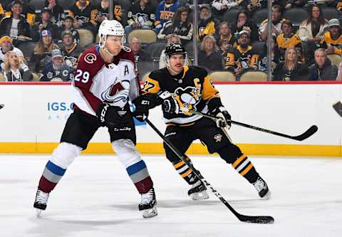 PITTSBURGH, PA – DECEMBER 04: Nathan MacKinnon #29 of the Colorado Avalanche skates alongside Sidney Crosby #87 of the Pittsburgh Penguins at PPG Paints Arena on December 4, 2018 in Pittsburgh, Pennsylvania. (Photo by Joe Sargent/NHLI via Getty Images)