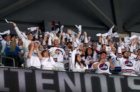 WINNIPEG, MB – APRIL 20: Winnipeg Jets fans clad all in white wave towels as they cheer the team on during first period action against the Minnesota Wild in Game Five of the Western Conference First Round during the 2018 NHL Stanley Cup Playoffs at the Bell MTS Place on April 20, 2018 in Winnipeg, Manitoba, Canada. The Jets defeated the Wild 5-0 and won the series 4-1. (Photo by Jonathan Kozub/NHLI via Getty Images)