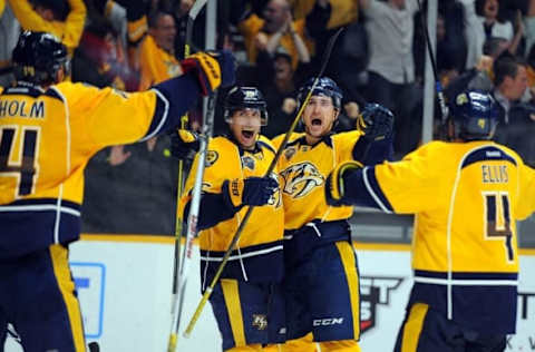 Mar 24, 2016; Nashville, TN, USA; Nashville Predators center Filip Forsberg (9) and Nashville Predators center Craig Smith (15) celebrate with teammates after a goal during the third period against the Vancouver Canucks at Bridgestone Arena. Mandatory Credit: Christopher Hanewinckel-USA TODAY Sports