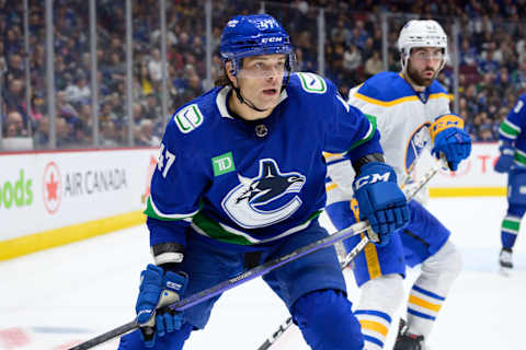 Noah Juulsen defending in the corner for the Vancouver Canucks. (Photo by Derek Cain/Getty Images)