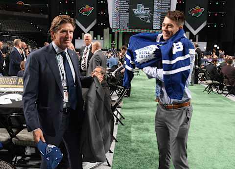 DALLAS, TX – JUNE 23: Head coach Mike Babcock helps Zachary Bouthillier after being selected 209th overall by the Toronto Maple Leafs during the 2018 NHL Draft at American Airlines Center on June 23, 2018 in Dallas, Texas. (Photo by Brian Babineau/NHLI via Getty Images)