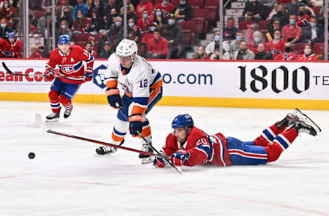 MONTREAL, QC – APRIL 15: Chris Wideman #20 of the Montreal Canadiens dives to poke the puck away from Josh Bailey #12 of the New York Islanders during the third period at Centre Bell on April 15, 2022 in Montreal, Canada. The New York Islanders defeated the Montreal Canadiens 3-0. (Photo by Minas Panagiotakis/Getty Images)