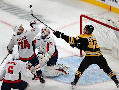 BOSTON – NOVEMBER 16: Boston Bruins’ Danton Heinen (43) gets his stick on a flying puck in front of Capitals goalie Braden Holtby (70) as the Capitals’ John Carlson takes a swipe at it in the first period. The Boston Bruins host the Washington Capitals in a regular season NHL hockey game at TD Garden in Boston on Nov. 16, 2019. (Photo by John Tlumacki/The Boston Globe via Getty Images)