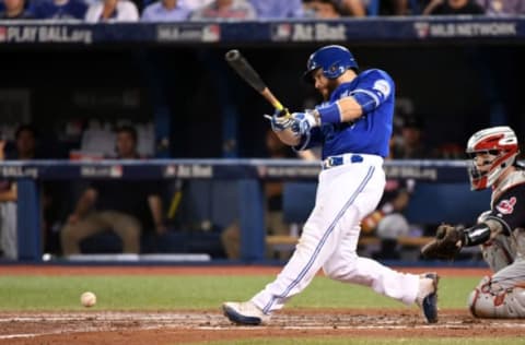 Oct 18, 2016; Toronto, Ontario, CAN; Toronto Blue Jays catcher Russell Martin (55) hits a single during the sixth inning against the Cleveland Indians in game four of the 2016 ALCS playoff baseball series at Rogers Centre. Mandatory Credit: Nick Turchiaro-USA TODAY Sports