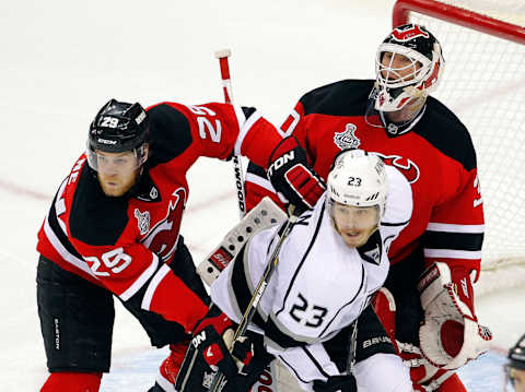 Mark Fayne boxes out Dustin Brown. (Photo by Paul Bereswill/Getty Images)