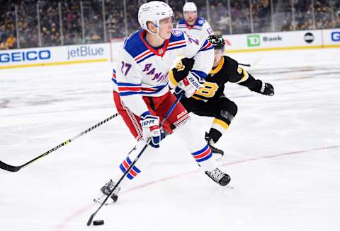 Nov 26, 2021; Boston, Massachusetts, USA; New York Rangers defenseman Nils Lundkvist (27) gets set to shoot the puck during the second period against the Boston Bruins at TD Garden. Mandatory Credit: Bob DeChiara-USA TODAY Sports