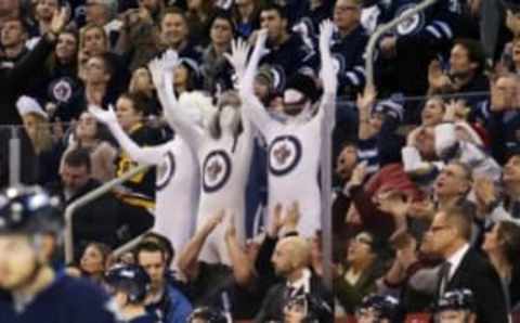 Dec 27, 2015; Winnipeg, Manitoba, CAN; Winnipeg Jets fans have some fun in their morph suits during the third period against the Pittsburgh Penguins at MTS Centre. Winnipeg wins 1-0. Mandatory Credit: Bruce Fedyck-USA TODAY Sports