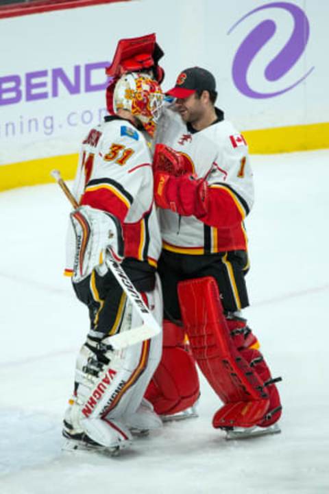 Nov 15, 2016; Saint Paul, MN, USA; Calgary Flames goalie Chad Johnson (31) celebrates with goalie Brian Elliott (1) following the game against the Minnesota Wild at Xcel Energy Center. The Flames defeated the Wild 1-0. Mandatory Credit: Brace Hemmelgarn-USA TODAY Sports