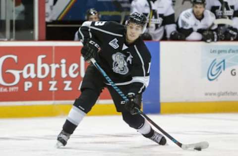 GATINEAU, CANADA – OCTOBER 30: Alex Dostie #13 of the Gatineau Olympiques fires the puck against the Blainville-Boisbriand Armada. (Photo by Francois Laplante/Freestyle Photography/Getty Images)