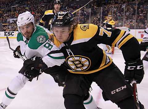 BOSTON – JANUARY 15: Boston Bruins defenseman Charlie McAvoy (73) is checked into the boards by Dallas Stars center Tyler Seguin (91) during the second period. The Boston Bruins host the Dallas Stars in a regular season NHL hockey game at TD Garden in Boston on Jan. 15, 2018. (Photo by Matthew J. Lee/The Boston Globe via Getty Images)