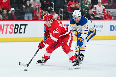 Apr 6, 2023; Detroit, Michigan, USA; Detroit Red Wings right wing Jonatan Berggren (52) brings the puck up ice as Buffalo Sabres center Casey Mittelstadt (37) defends during overtime at Little Caesars Arena. Mandatory Credit: Tim Fuller-USA TODAY Sports