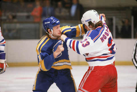 Canadian professional hockey player Brian Sutter of the St. Louis Blues grapples with American colleague Eddie Hospodar of the New York Rangers, Madison Square Garden, New York, May 1981. (Photo by Bruce Bennett Studios via Getty Images Studios/Getty Images)