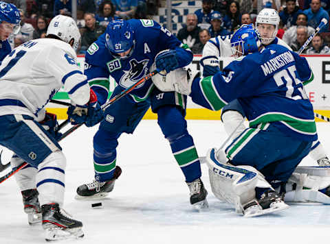 Goalie Jacob Markstrom #25 of the Vancouver Canucks scrambles to find the puck. (Photo by Rich Lam/Getty Images)