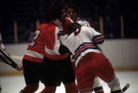 Dave Schultz of the Philadelphia Flyers fights with Glen Sather at Madison Square Garden in New York, New York. (Photo by Melchior DiGiacomo/Getty Images)