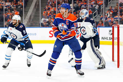 Oct 21, 2023; Edmonton, Alberta, CAN; Edmonton Oilers forward Connor McDavid (97) looks for a pass in front of Winnipeg Jets goaltender Connor Hellebuyck (37) during the first period at Rogers Place. Mandatory Credit: Perry Nelson-USA TODAY Sports