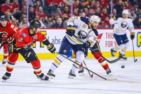 Dec 10, 2015; Calgary, Alberta, CAN; Buffalo Sabres center Ryan O’Reilly (90) and Calgary Flames defenseman Dennis Wideman (6) battle for the puck during the first period at Scotiabank Saddledome. Mandatory Credit: Sergei Belski-USA TODAY Sports