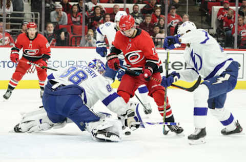 RALEIGH, NC – JANUARY 05: Tampa Bay Lightning Goalie Andrei Vasilevskiy (88) finds a loose puck in front of Carolina Hurricanes Center Sebastian Aho (20) during a game between the Tampa Bay Lightning and the Carolina Hurricanes on January 5, 2020 at the PNC Arena in Raleigh, NC. (Photo by Greg Thompson/Icon Sportswire via Getty Images)