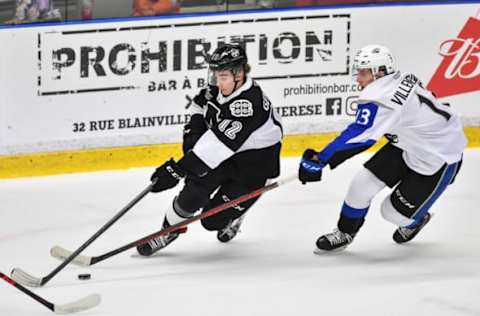 BOISBRIAND, QC – DECEMBER 03: Alexis Gendron #12 of the Blainville-Boisbriand Armada skates with the puck against William Villeneuve #13 of the Saint John Sea Dogs during the first period at Centre d’Excellence Sports Rousseau on December 3, 2021 in Boisbriand, Quebec, Canada. (Photo by Minas Panagiotakis/Getty Images)