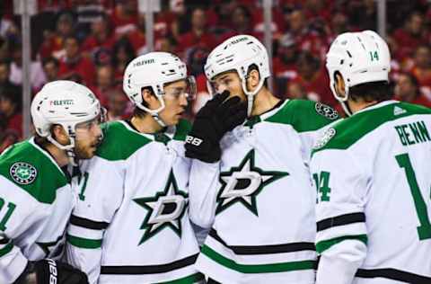 CALGARY, AB – MAY 11: (L-R) Tyler Seguin #91, Jason Robertson #21, Jani Hakanpaa #2 and Jamie Benn #14 of the Dallas Stars confer during a break in first period play against the Calgary Flames in Game Five of the First Round of the 2022 Stanley Cup Playoffs at Scotiabank Saddledome on May 11, 2022 in Calgary, Alberta, Canada. (Photo by Derek Leung/Getty Images)