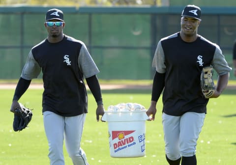 GLENDALE, ARIZONA – FEBRUARY 20: Luis Robert (L) and Eloy Jimenez of the Chicago White Sox carry a bucket of baseballs during a spring training workout February 20, 2018 at Camelback Ranch in Glendale Arizona. (Photo by Ron Vesely/MLB Photos via Getty Images)