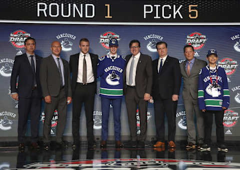 CHICAGO, IL – JUNE 23: (L-R) Head coach Travis Green, scout David Volek, draft team member, fifth overall pick Elias Pettersson, chairman Francesco Aquilini, general manger Jim Benning, director of amateur scouting Judd Brackett and the draft runner of the Vancouver Canucks pose for a photo onstage during Round One of the 2017 NHL Draft at United Center on June 23, 2017 in Chicago, Illinois. (Photo by Dave Sandford/NHLI via Getty Images)