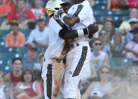 Aug 15, 2015; Chicago, IL, USA; National team Taylor Trammel (left) and Delvin Perez (right) celebrate after scoring against the American team during the fifth inning in the Under Armour All America Baseball game at Wrigley field. Mandatory Credit: David Banks-USA TODAY Sports