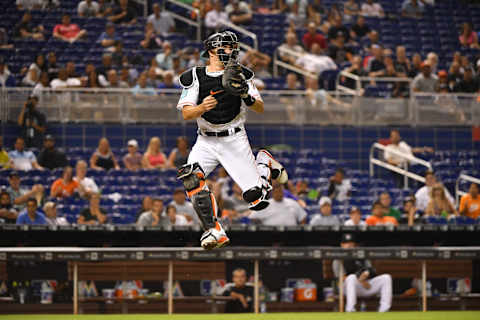 MIAMI, FL – JULY 23: J.T. Realmuto #11 of the Miami Marlins attempts to catch the throw from the outfield in the seventh inning against the Atlanta Braves at Marlins Park on July 23, 2018 in Miami, Florida. (Photo by Mark Brown/Getty Images)