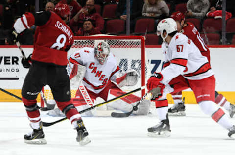 GLENDALE, ARIZONA – FEBRUARY 06: Goalie James Reimer #47 of the Carolina Hurricanes makes a blocker save on the shot by Nick Schmaltz #8 of the Arizona Coyotes as Trevor van Riemsdyk #57 of the Hurricanes defends during the second period of the NHL hockey game at Gila River Arena on February 06, 2020 in Glendale, Arizona. (Photo by Norm Hall/NHLI via Getty Images)