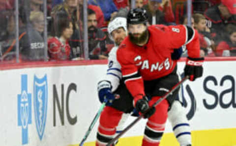 RALEIGH, NORTH CAROLINA – NOVEMBER 06: Zach Aston-Reese #12 of the Toronto Maple Leafs battles Brent Burns #8 of the Carolina Hurricanes for the puck during the third period of their game at PNC Arena on November 06, 2022 in Raleigh, North Carolina. The Maple Leafs defeated the Hurricanes 3-1. (Photo by Grant Halverson/Getty Images)