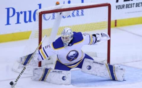 Feb 20, 2021; Newark, New Jersey, USA; Buffalo Sabres goaltender Linus Ullmark (35) sticks the puck aside against the New Jersey Devils during the third period at Prudential Center. Mandatory Credit: Vincent Carchietta-USA TODAY Sports