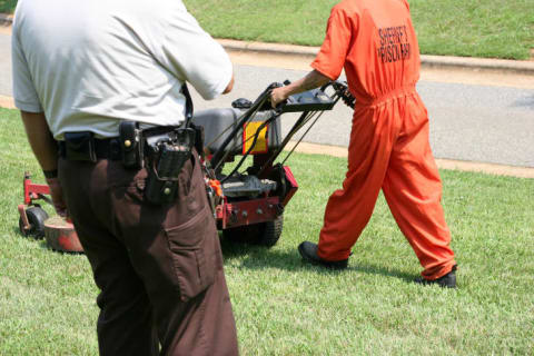 Prison Laborer mowing a lawn