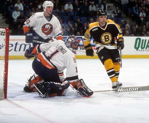 UNIONDALE, NY – DECEMBER 27: Goalie Roberto Luongo #1 of the New York Islanders tries for the poke check as teammate Eric Cairns #33 follows Andre Savage #28 of the Boston Bruins on December 27, 1999 at the Nassau Coliseum in Uniondale, New York. (Photo by B Bennett/Getty Images)