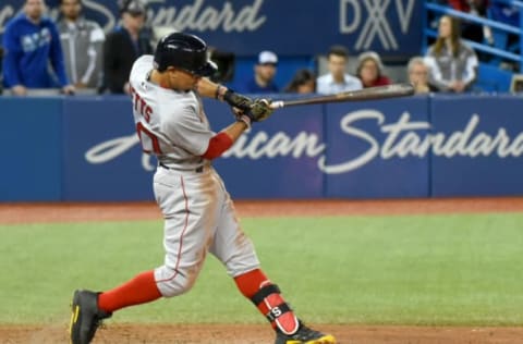 Apr 20, 2017; Toronto, Ontario, CAN; Boston Red Sox right fielder Mookie Betts (50) hits a double to score three runs against Toronto Blue Jays in the tenth inning at Rogers Centre. Mandatory Credit: Dan Hamilton-USA TODAY Sports