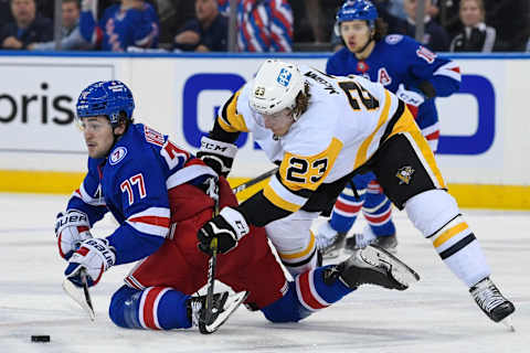 May 5, 2022; New York, New York, USA; Pittsburgh Penguins left wing Brock McGinn (23) and New York Rangers center Frank Vatrano (77) battle for a loose puck during the second period in game two of the first round of the 2022 Stanley Cup Playoffs at Madison Square Garden. Mandatory Credit: Dennis Schneidler-USA TODAY Sports