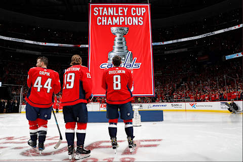 WASHINGTON, DC – OCTOBER 03: Alex Ovechkin #8, Nicklas Backstrom #19, and Brooks Orpik #44 of the Washington Capitals watch the 2018 Stanley Cup Championship banner rise to the rafters before playing against the Boston Bruins at Capital One Arena on October 3, 2018 in Washington, DC. (Photo by Patrick McDermott/NHLI via Getty Images)