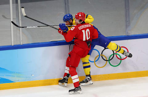 BEIJING, CHINA – FEBRUARY 18: Dmitri Voronkov #10 of Team ROC checks Christian Folin #2 of Team Sweden in the third period during the Men’s Ice Hockey Playoff Semifinal match between Team ROC and Team Sweden on Day 14 of the Beijing 2022 Winter Olympic Games at National Indoor Stadium on February 18, 2022 in Beijing, China. (Photo by Elsa/Getty Images)