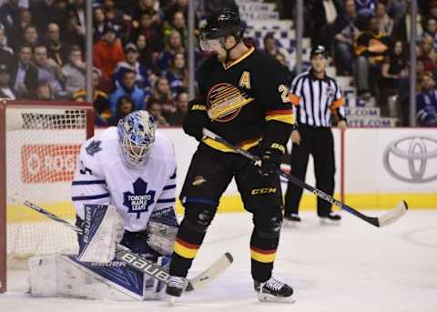 Feb 13, 2016; Vancouver, British Columbia, CAN; Toronto Maple Leafs goaltender James Reimer (34) makes a save as Vancouver Canucks forward Daniel Sedin (22) stands in front of the net during the first period at Rogers Arena. Mandatory Credit: Anne-Marie Sorvin-USA TODAY Sports