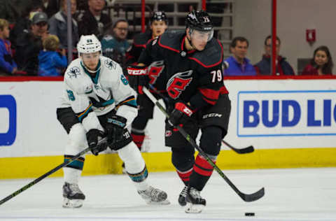 RALEIGH, NC – OCTOBER 26: Carolina Hurricanes Left Wing Micheal Ferland (79) skates the puck away from San Jose Sharks Winger Melker Karlsson (68) during a game between the Carolina Hurricanes and the San Jose Sharks at the PNC Arena in Raleigh, NC on October 26, 2018. Carolina defeated San Jose 4-3 in a shootout. (Photo by Greg Thompson/Icon Sportswire via Getty Images)