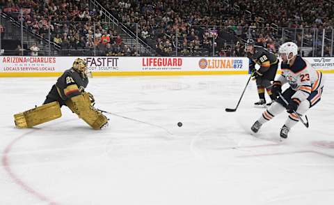 Marc-Andre Fleury of the Vegas Golden Knights comes out of the crease to poke check the puck to stop a breakaway by Riley Sheahan of the Edmonton Oilers in the third period of their game at T-Mobile Arena on February 26, 2020.